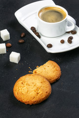 white cup of fresh hot coffee, grains of coffee and sugar cubes