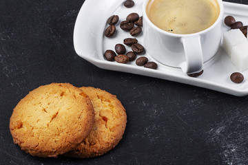 white cup of fresh hot coffee and grains of coffee