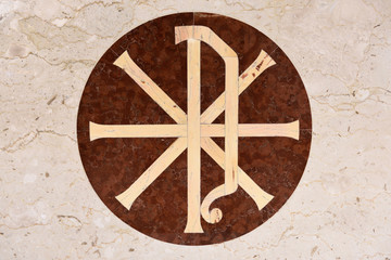 Christian Chi Rho PX symbol for first two Greek letters of Christ on inlaid marble of Catholic church altar Toronto