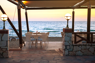 Entrance to empty cafe on sandy beach at sunset. concept of travel and vacation. velvet season