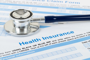 Health insurance application form with stethoscope and calculator