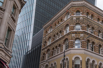 Fantastic classic architecture in City of London with skyscrapers in background
