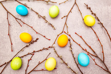 Fototapeta na wymiar Easter eggs concept willow seals branches on a stone background wallpaper, top view.