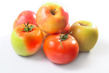 A hybrid of apple and tomato on a white background among other apples