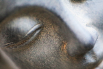 Buddha face close up shot. Buddhist religion concept idea