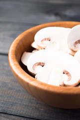 Sliced raw white champignons preparing for cooking