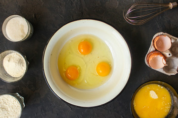 raw dough mix ingredients (eggs, flour and others). food background. copy space