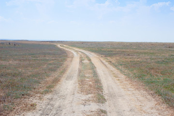Fototapeta na wymiar road to the arid steppe