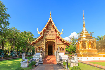 Fototapeta premium Chapel and golden pagoda at Wat Phra Singh Woramahawihan in Chiang Mai, North of Thailand