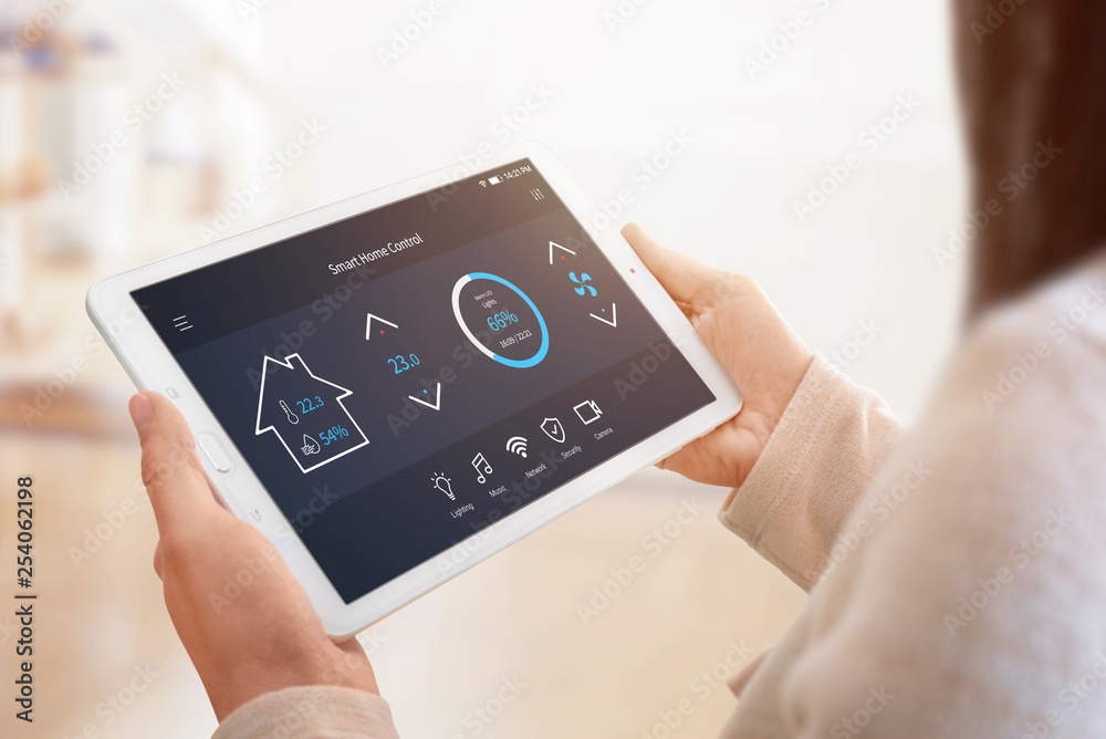 Poster modern home control app with flat interface on tablet display. woman holding tablet. sun light in ba