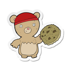sticker of a cartoon teddy bear with cookie
