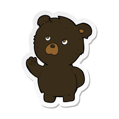 sticker of a cartoon waving black bear