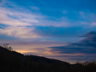 Beautiful landscape in the mountains at sunset. View of colorful sky with amazing clouds.