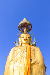 Standing golden Buddha statue at Wat Intharawihan, Bangkok, one of the tallest in Thailand
