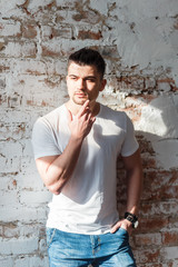 Fototapeta premium man in t-shirt and jeans standing in loft room