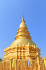 Naklejka premium Golden pagoda at Wat Phra That Haripunchai Woramahawihan in Lamphun, north of Thailand