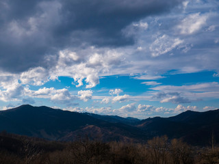 Beautiful landscape in the mountains at sunset. View of colorful sky with amazing clouds.