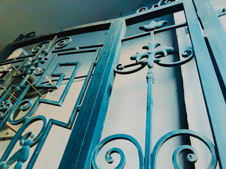 Ornament, detail of an iron gate. Iron-forged gates decor and ornament in the city streets. Old...