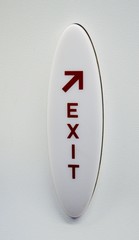 Red and white exit sign on an aircraft