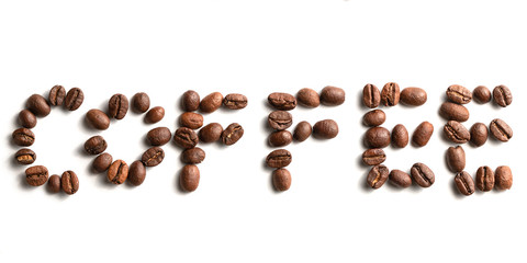 Coffee Beans arranged in letters spelling word Coffee. Coffee Background. Coffee Bean Arrangement. Fresh Roasted Coffee. Cafe Food and Drink Close Up isolated on white background.