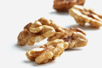 walnut kernels scattered on a white table