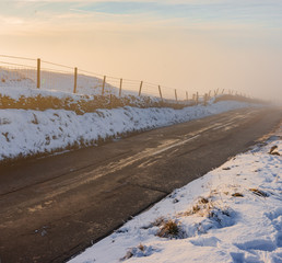 A deep fog rises from a country road in the middle of winter, 2019