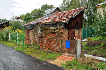 Old brick farm building with a tiled roof.