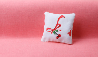 Pillow with cherry and ribbon