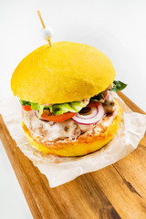 yellow vegan burger with vegetables and mushroom cutlet