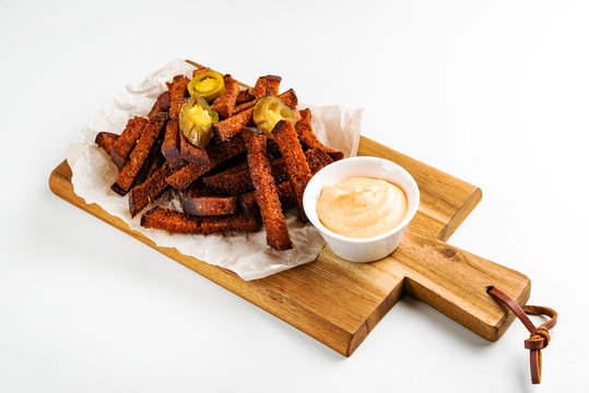 beer appetizer with sauce on the wooden board