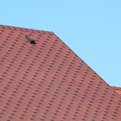 Decorative metal tile on a roof