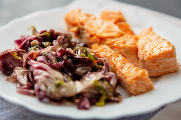 plate with salmon and red radicchio garnish