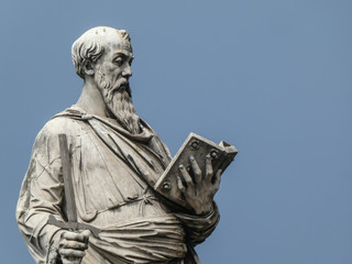 Statue of the apostle St. Paul holding a broken sword and a book with the pedestal inscription...