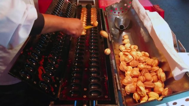 Baking mini pancakes on a Japaneses street food festival