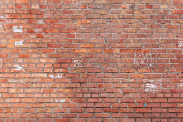 Old brick wall with scratches, cracks, dust, crevices, roughness. Can be used as a poster or background for design.