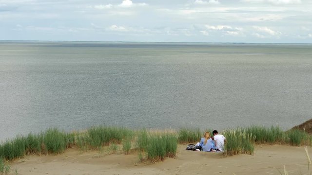 Family on Parnidis sand dune. One the the most beautiful and popular tourist points. Located in Nida, Curonian Spit. Unesco heritage site.