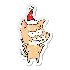 distressed sticker cartoon of a grinning fox wearing santa hat
