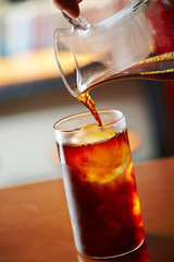 Pouring coffee in iced water 