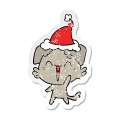 happy little dog distressed sticker cartoon of a wearing santa hat