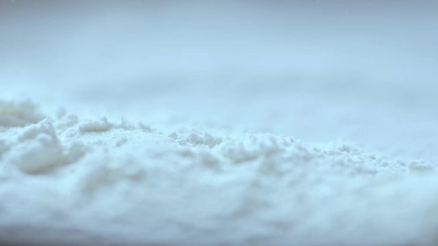 Slow motion, Red blood dropping into white cocaine powder, macro shot