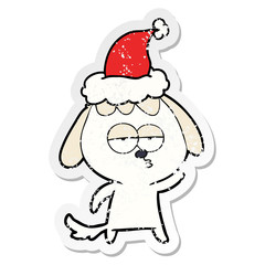 distressed sticker cartoon of a bored dog wearing santa hat
