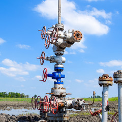 Oil well after repair in mud and puddles.