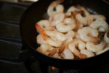 Grilling shrimps in frying pan