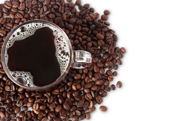 coffee cup with dark roasted coffee beans closeup on white background top view
