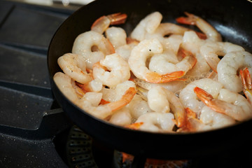Grilling shrimps in frying pan