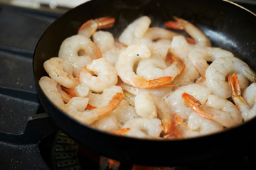 Grilling shrimps in frying pan