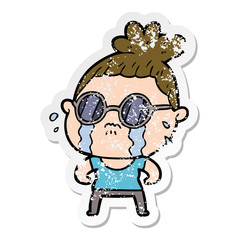 distressed sticker of a cartoon crying woman wearing sunglasses