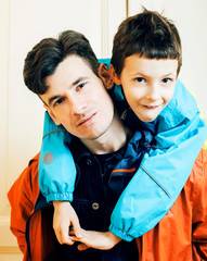 young handsome father with his son fooling around at home, lifestyle people concept close up