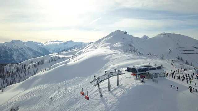 4k Drone shot of a Ski Lift on a perfect snowy mountain with people Wintersport Flachau, Austria