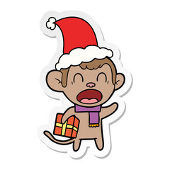 shouting sticker cartoon of a monkey carrying christmas gift wearing santa hat